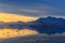 Sunset over idyllic lagoon with mountains and icebergs in the ba