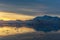 Sunset over idyllic lagoon with mountains and icebergs in the ba