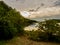 Sunset over Keystone Lake in Keystone State Park in Pennsylvania in the Laurel Highlands.  Golden glow over the water with a cloud