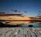 Sunset over a lake and blue bricks floor