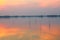 Sunset over lake , Man rows a fishing boat