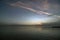 After sunset over Lake Ohrid with colorful clouds and traces of airplane.