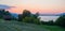 Sunset over lake Thunersee, mowed meadow and hut, idyllic landscape Berner Oberland
