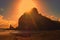 Sunset over Lions rock at Piha beach, New Zealand