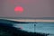 sunset over low tide breakwaters