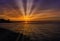 Sunset over Malecon and Atlantic Ocean with visible sun rays