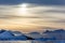 Sunset over the mountains with glaciers and drifting icebergs at