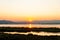 Sunset over mountains on river ebro delta national park with reflections, a scenic landcape of serenity and relax