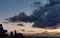 Sunset over the mountains and valleys of the Apennines with large colored clouds laden with rain