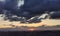 Sunset over the mountains and valleys of the Apennines with large colored clouds laden with rain