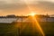 Sunset over a photovoltaic power plant with photovoltaic modules for renewable energy on the field. Solar power generation