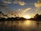 Sunset over pond surrounded by coconut trees at Ala Moana Beach Park