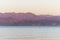 Sunset over the Red sea with pink orange mountains on the background. Eilat, Aqaba, Israel, Jordan