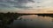 Sunset over the river, boat station, seagulls against the sky and people in the boat