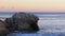 Sunset over the rock formations of Natural Bridges State Beach, Santa Cruz