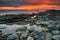 Sunset over rocky beach at Koh Lanta island in Thailand.