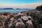 Sunset over rough volcanic rock coastline landscape