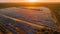 Sunset over rural landscape with solar panels and wind turbines generated by AI