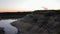 Sunset over the sand rock and lake landscape