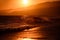 Sunset over sea with golden dramatic sky panorama. Calm sea with sunset sky. Ocean and sky background. Waves splashes.