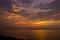 Sunset over sea with moody sky, dark storm clouds