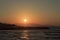 Sunset over the sea and the mountains in Kokkini Hani, Crete, Greece. Scenic seaside landscape in the evening