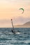 Sunset over the sea or ocean and extreme freestyle sport windsurfing