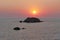 Sunset over the sea at Prasoudi, Corfu seen from the balcony of a tavern