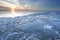 Sunset over shelf ice on frozen lake