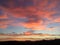 Sunset over a silhouetted mountain