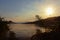 Sunset over silhouettes of mountains and shrubs on the embankments of river Danube, Romania