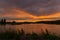 Sunset over a small lake in summer in Bashkiria