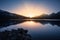 Sunset over snowy mountains and Lake Calacuccia in Corsica