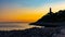 Sunset over southern rocky shore of Cap Ferrat cape at French Riviera of Mediterranean Sea with Le Phare lighthouse in France