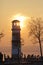 Sunset over a tall lighthouse