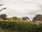 Sunset over the tops of an allotment garden sheds outside