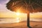 Sunset over tropical sandbank island with sunshade at sunset. Ma