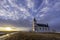 Sunset over a vast sky and the historic Zion Lutheran Church of the Flowing Well near Hodgeville, SK