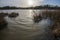 Sunset over the winter floods at Pebsham Lake near Bexhill in East Sussex, England