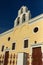 Sunset over yellow church, Fira, Santorini island, Thira, Greece