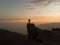 Sunset panorama hiker poncho on Marcahuasi andes plateau rock formations mountain hill valley nature landscape Lima Peru