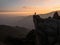 Sunset panorama hiker poncho on Marcahuasi andes plateau rock formations mountain hill valley nature landscape Lima Peru