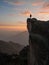 Sunset panorama hiker poncho on Marcahuasi andes plateau rock formations mountain hill valley nature landscape Lima Peru