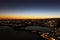 Sunset panorama over northern Lombardy lakes showing light pollution and Alps sihouette