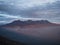 Sunset panorama of Picchu Picchu mountain range silhouette haze dust fog clouds from Misti volcano Arequipa Peru Andes