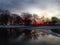 Sunset in a Park with Ice on Frozen Pond in Winter.