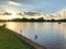 the sunset in the park reflecting your rays in the lake bringing the peaceful and relaxing view.