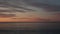 Sunset on pebble beach with sea waves of mediterranean sea