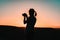 Sunset photographer: A woman\\\'s silhouette embraces the fading light, camera in hand, capturing the magic of the moment in a