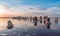 Sunset on a pink salt lake, a former mine for the extraction of pink salt. row of wooden pegs overgrown with salt